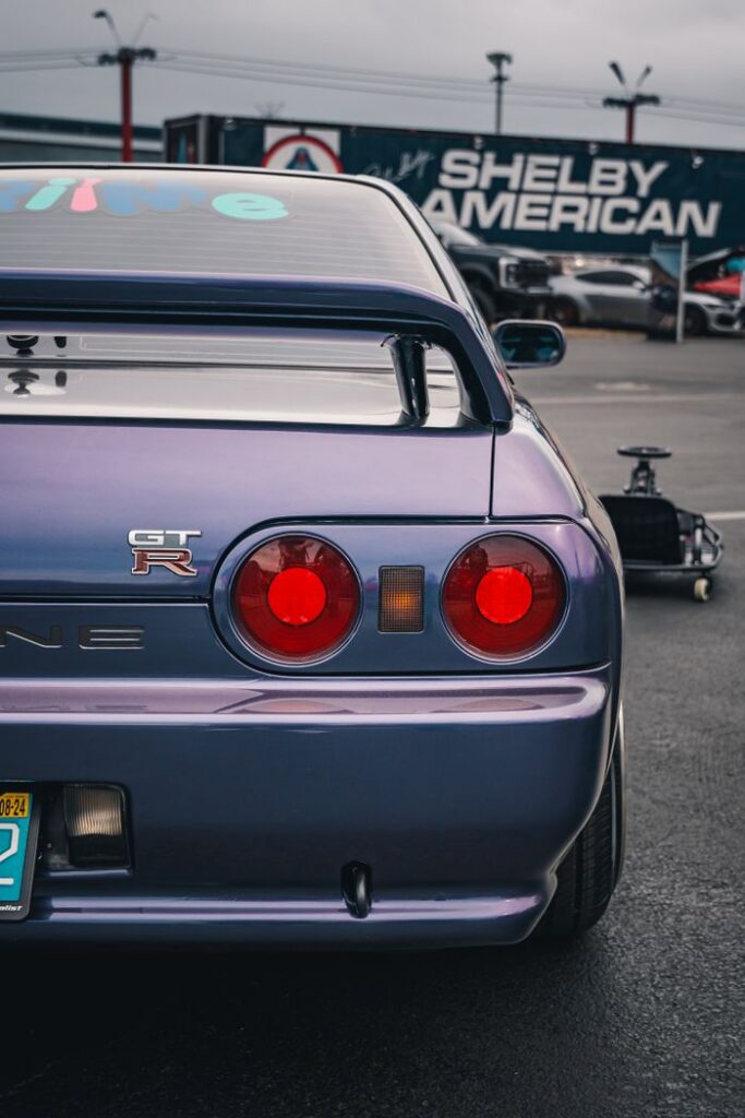 Close-up of a Nissan GT-R R32's tail lights in Tampa, showcasing its iconic JDM design.